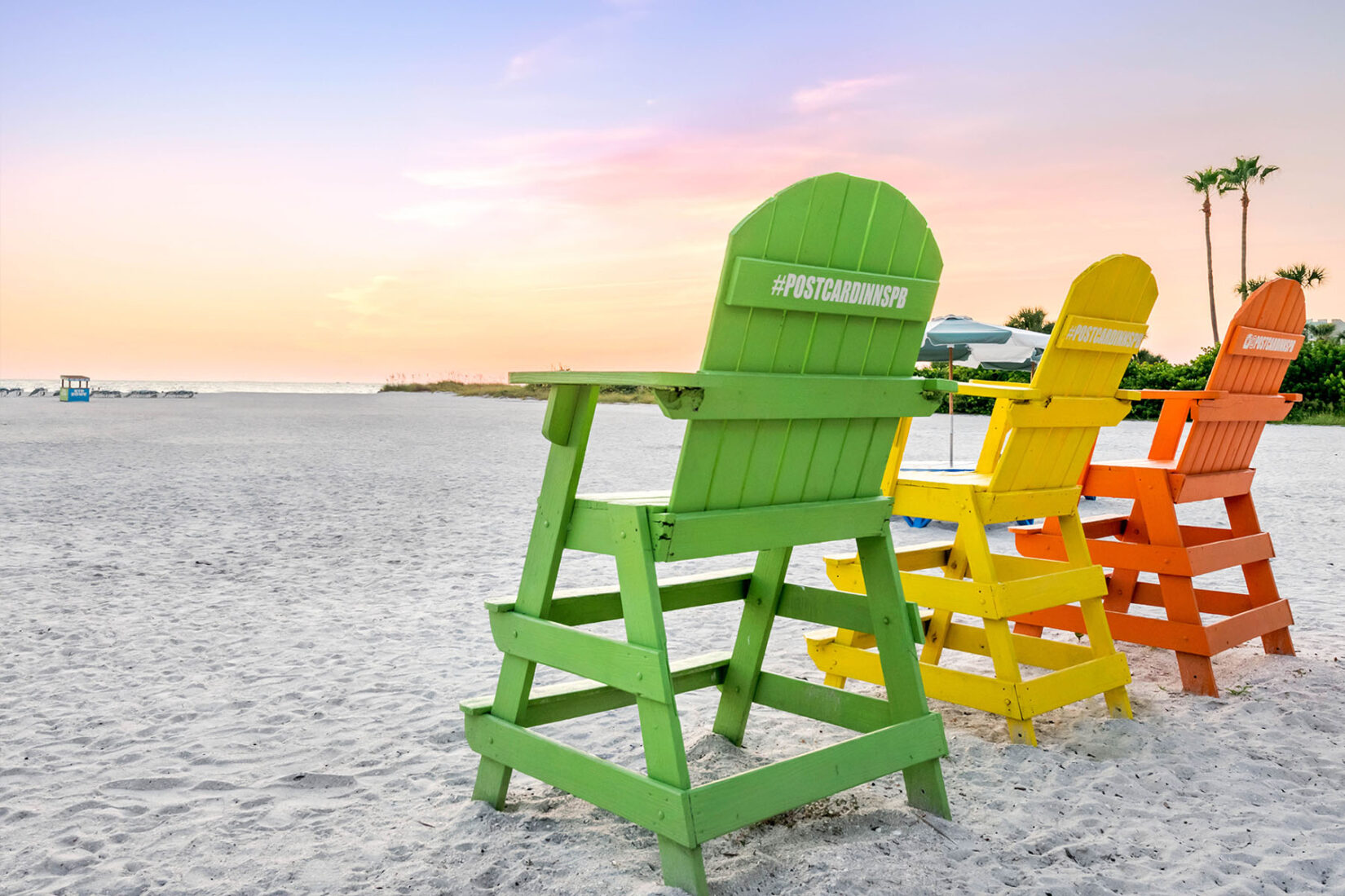 Colorful Wooden Postcard Inn Chairs in the Sand on the Beach