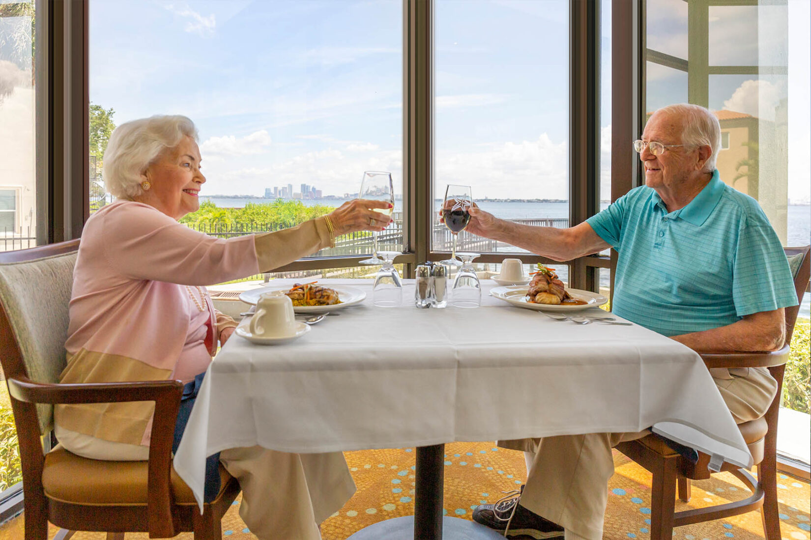 Happy Elderly Couple Cheersing at Senior Living Community