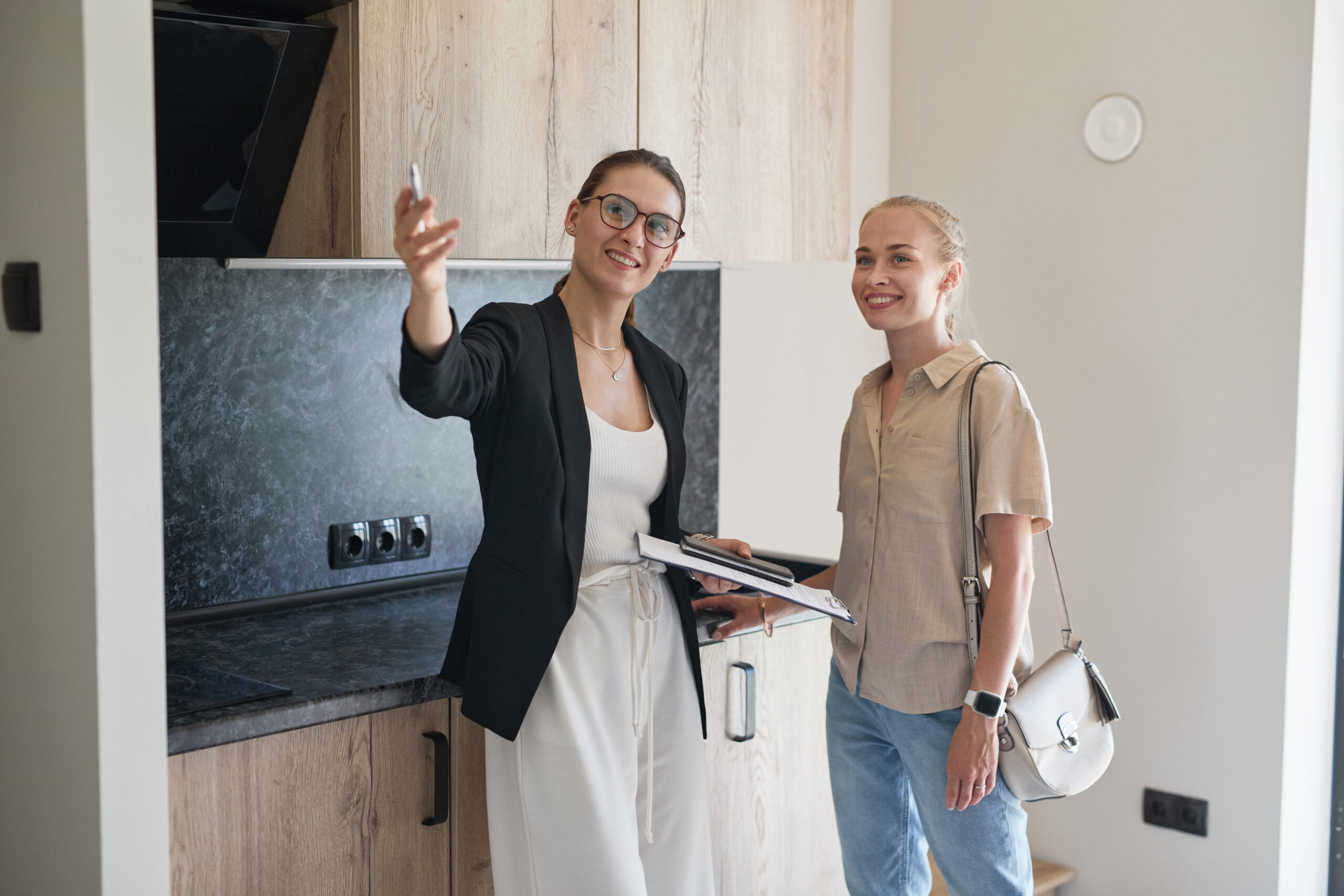 Realtor giving a woman an in-person tour of a property