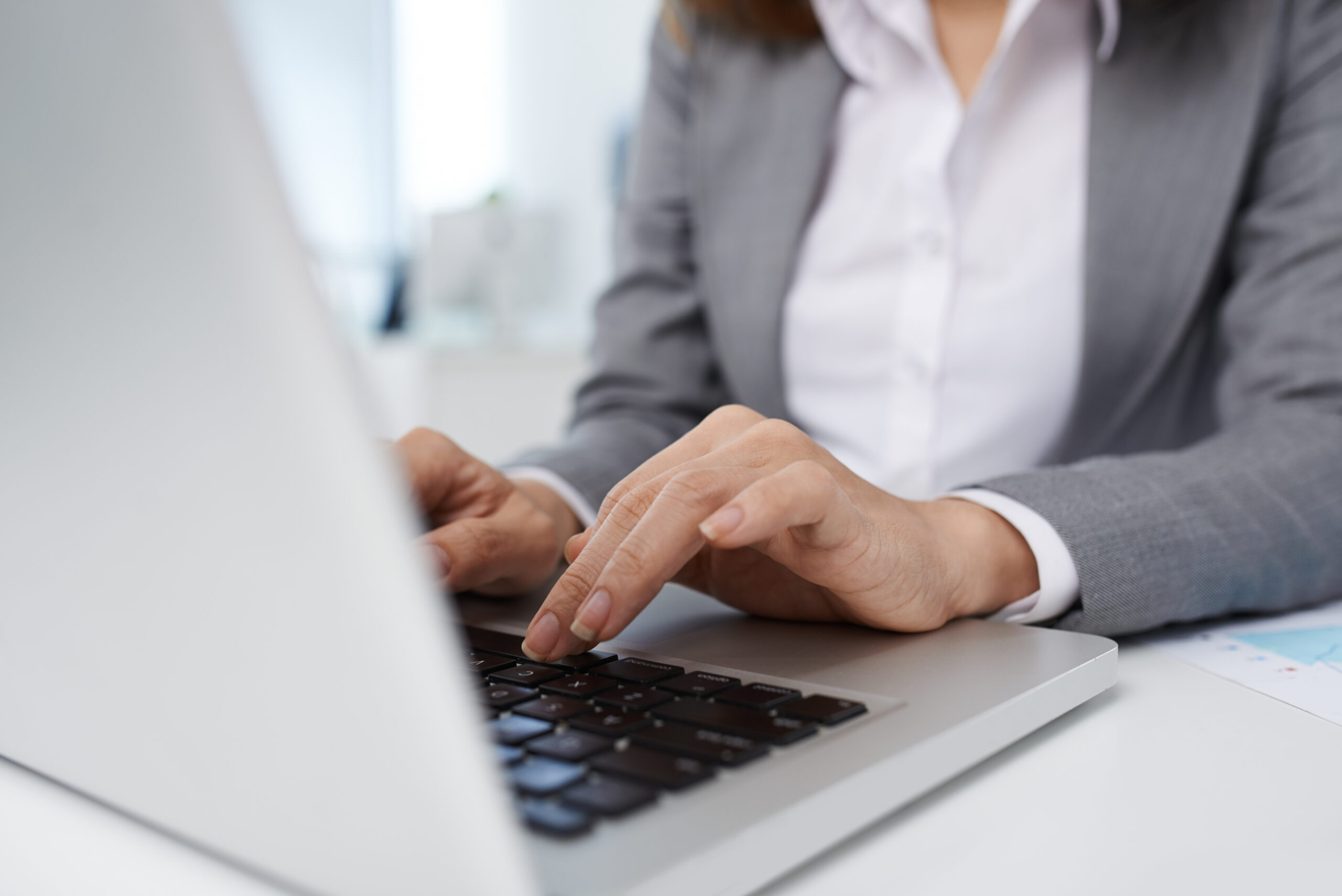 Close-up image of business lady working on laptop