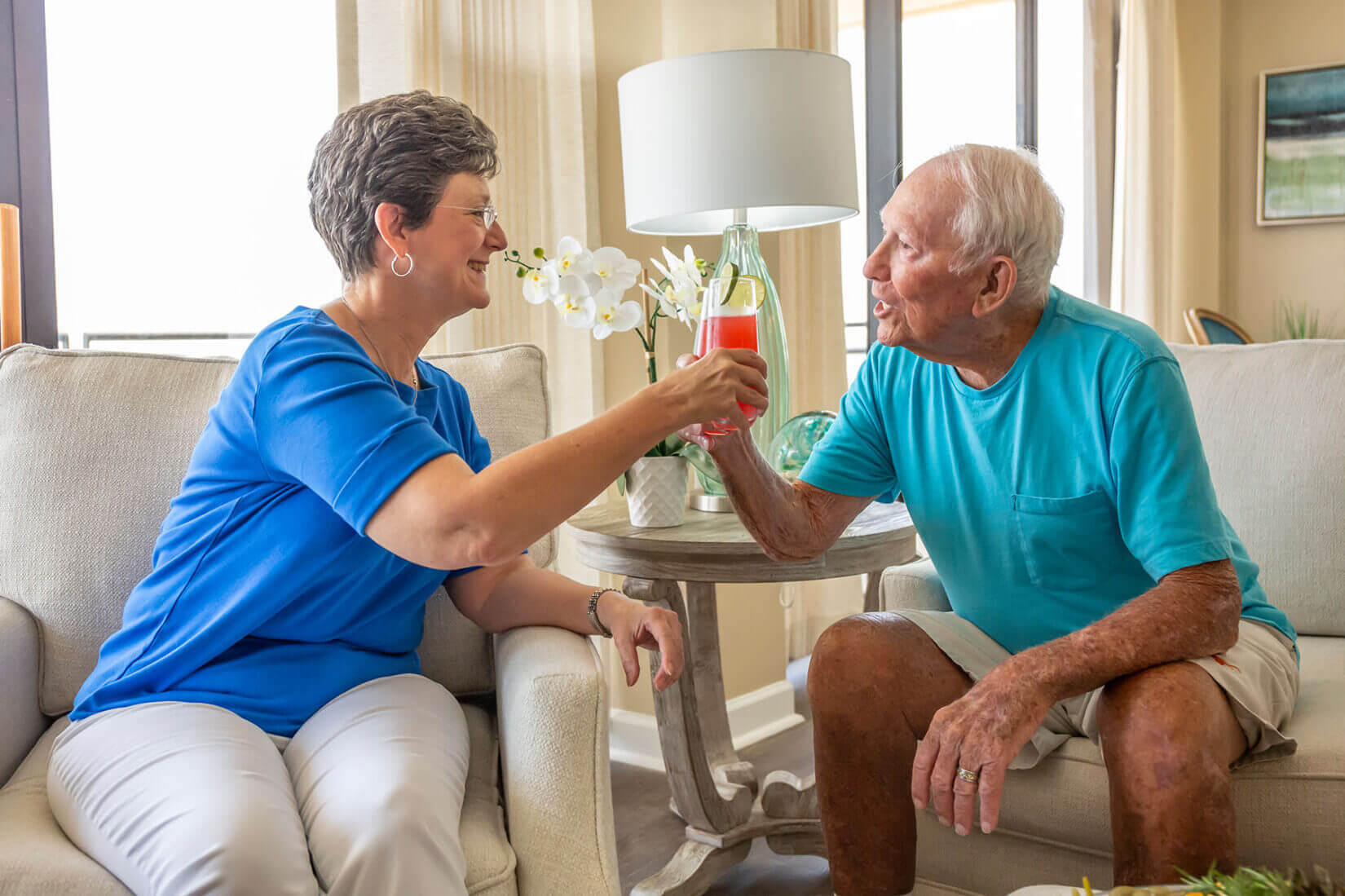 Senior living community with stone and stucco buildings, landscaped grounds and a covered entrance.